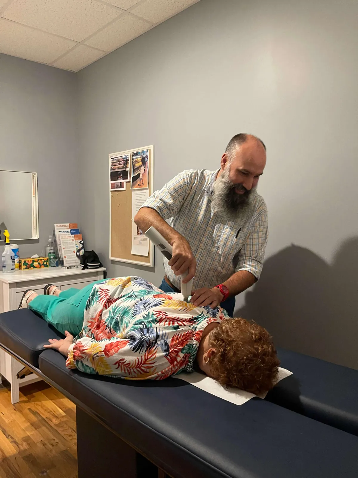 Dr. Jerry Pokorney performing a gentle chiropractic adjustment using the Activator Methods® instrument at Pure Chiropractic in Concord, NC