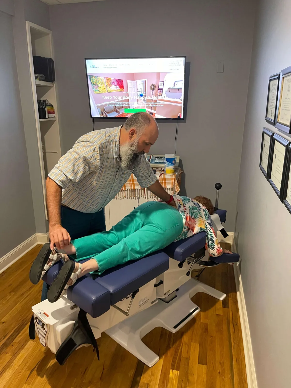 Dr. Jerry Pokorney providing spinal chiropractic adjustment using the Cox® Flexion-Distraction table at Pure Chiropractic in Concord, NC