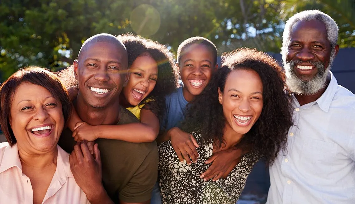 a black buddha statue sitting on top of a wooden table