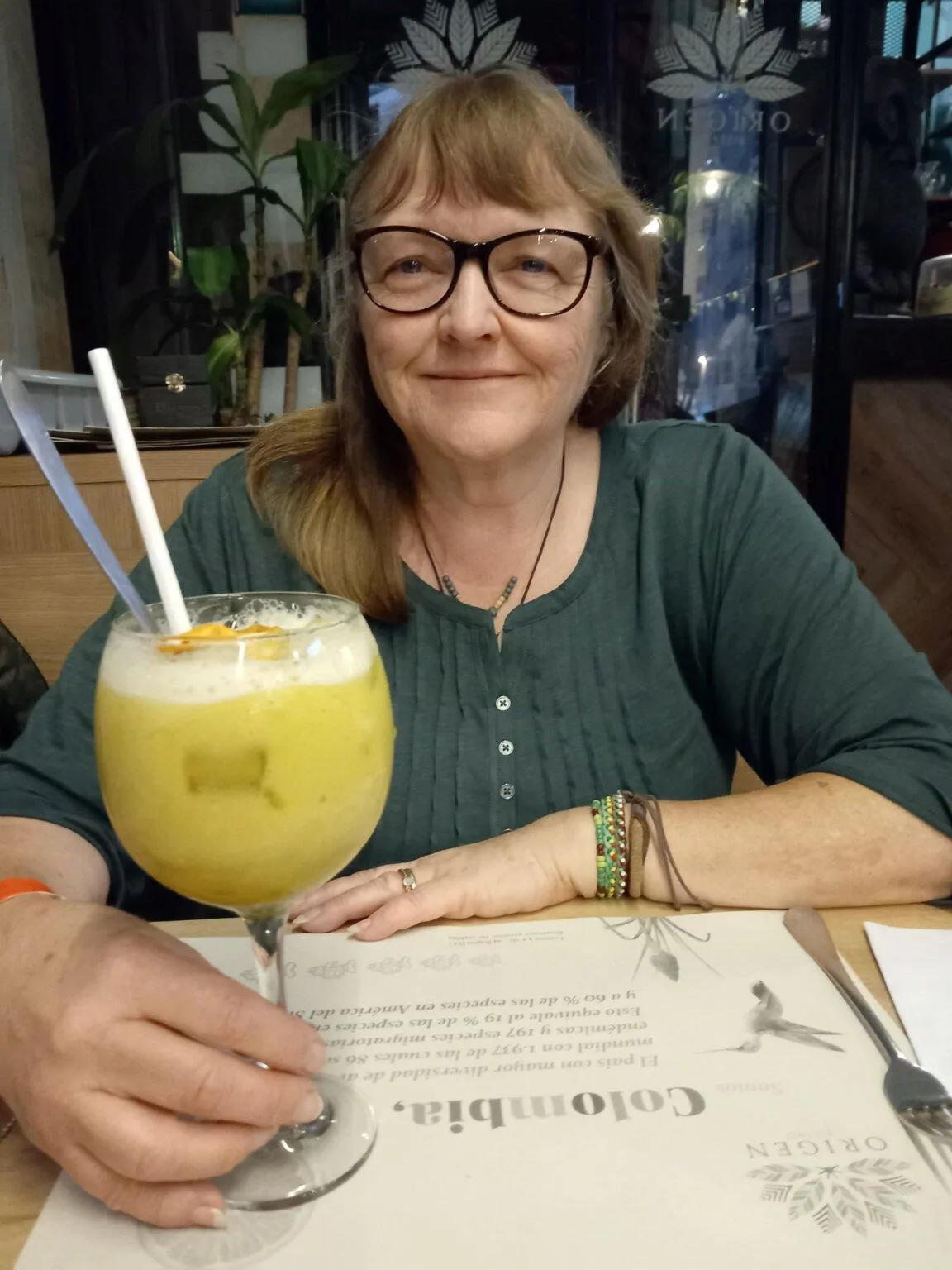 Andrea with a large glass of lulada a citrussy, non-alcoholic cocktail