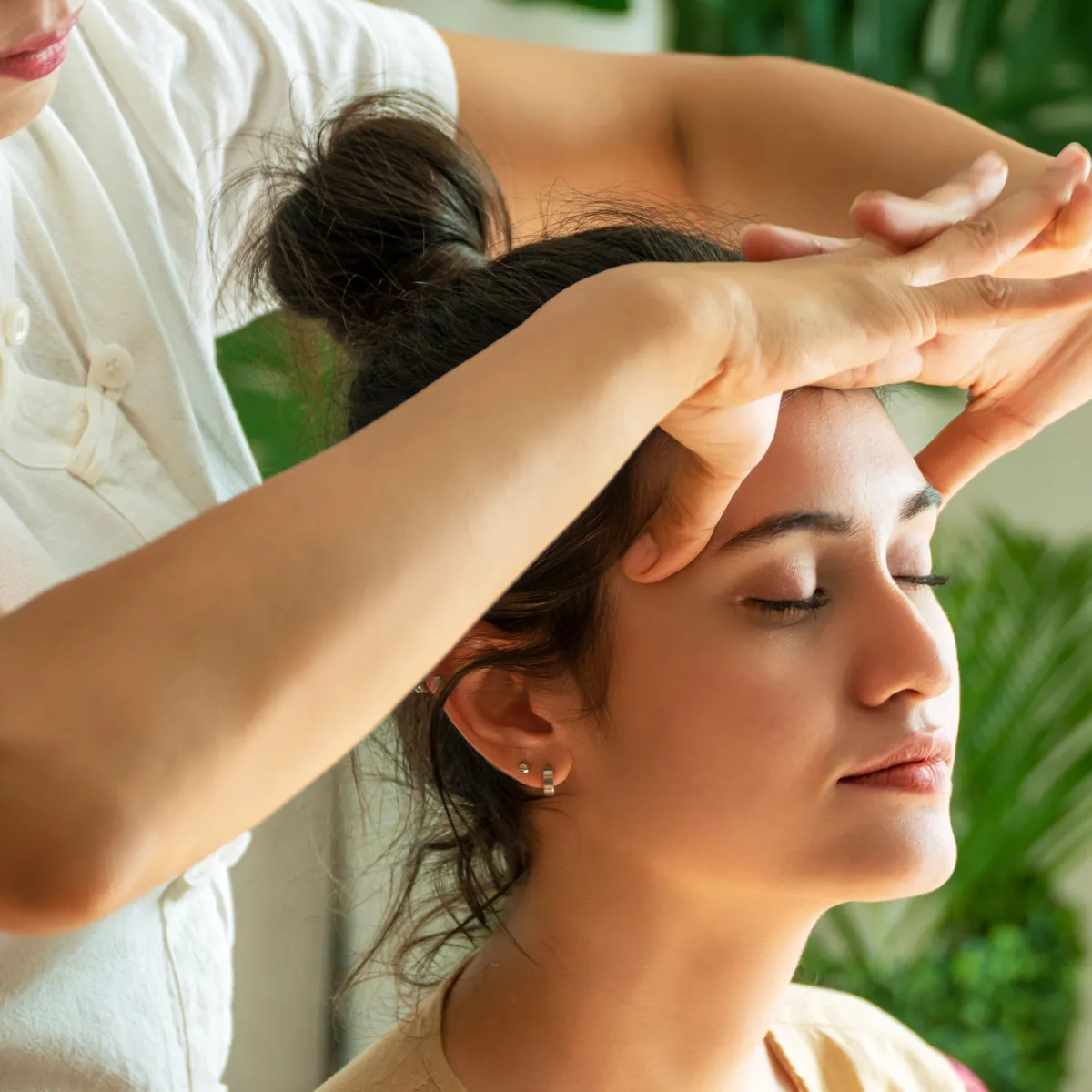 Reflexology treatment with therapist applying pressure to foot points to promote relaxation, circulation, and holistic wellness