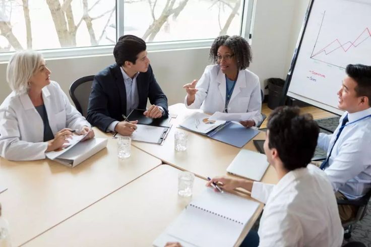 Hands-on nutrition workshop, group preparing healthy meals, instructor guiding