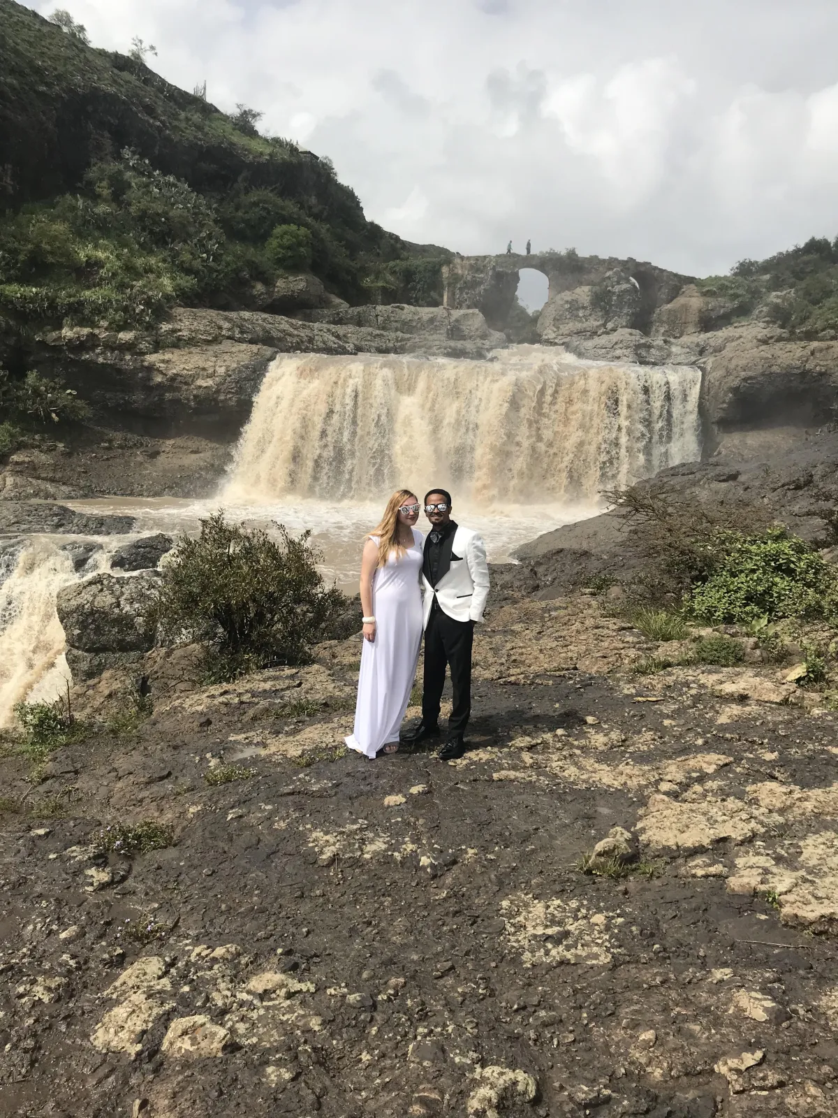 Wedding photo of Abraham and Hannah in front of a waterfall in Ethiopia