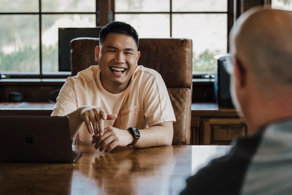 Vee Khuu, a leading figure in Generative AI consulting and a Forbes contributor, engages with a client, reflecting his expertise as a business AI trainer and real estate AI speaker, known for empowering growth through innovative AI solutions.