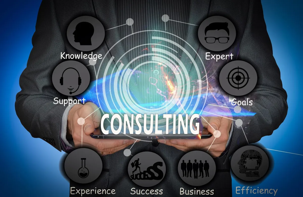 Vee Khuu presents AI business consulting services in an image featuring a businessman with a tablet that projects key consulting concepts. It illustrates the strategic application of AI in enhancing efficiency and customer experiences for business growth