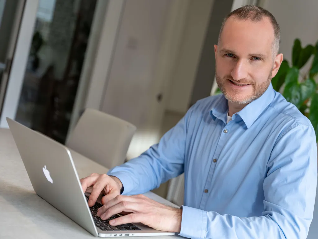 CEO sitting at desk working on laptop