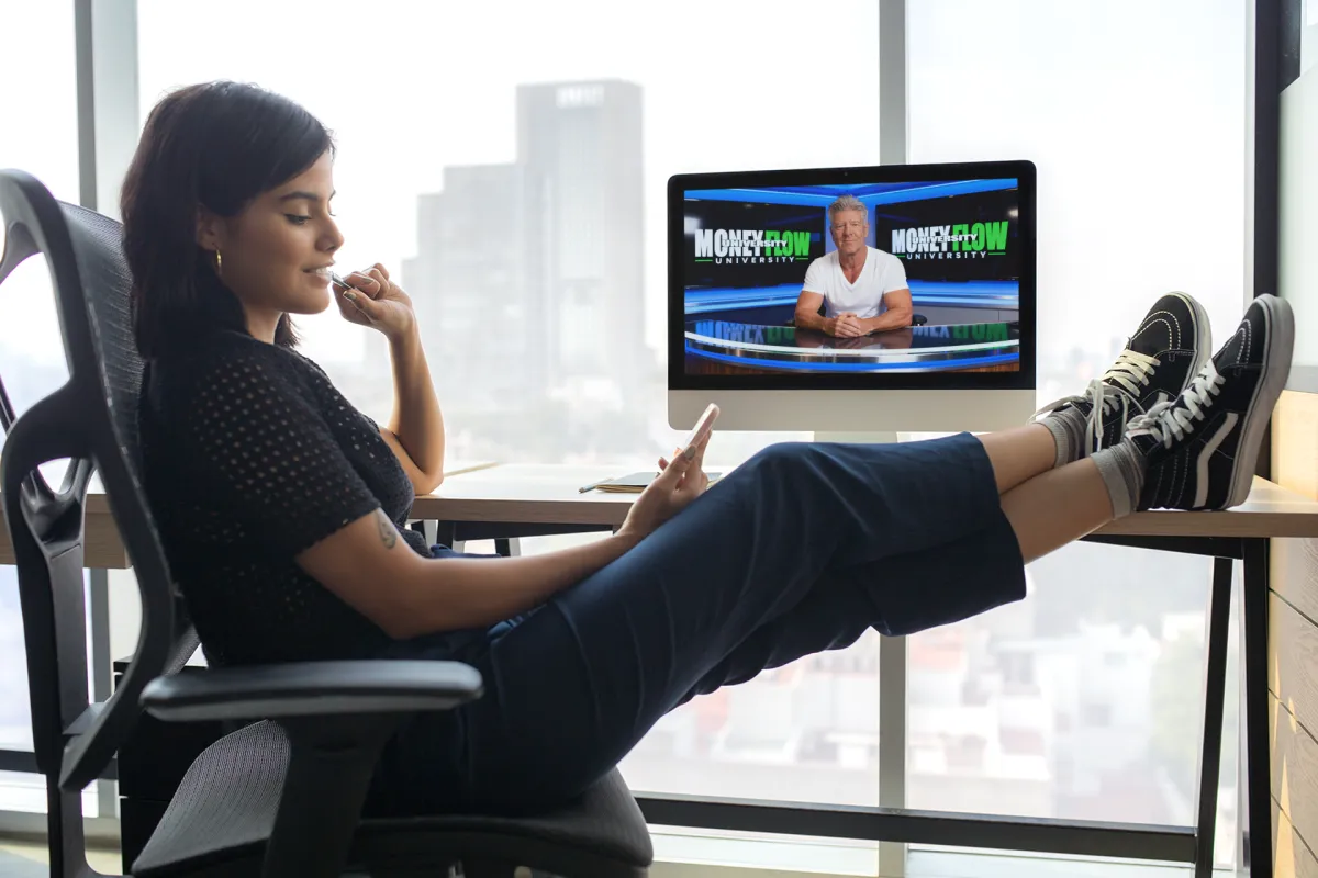 A small group coaching session in a modern studio: three people around a table reviewing a printed workbook, natural window light, photorealistic, conveys collaboration and credible instruction.