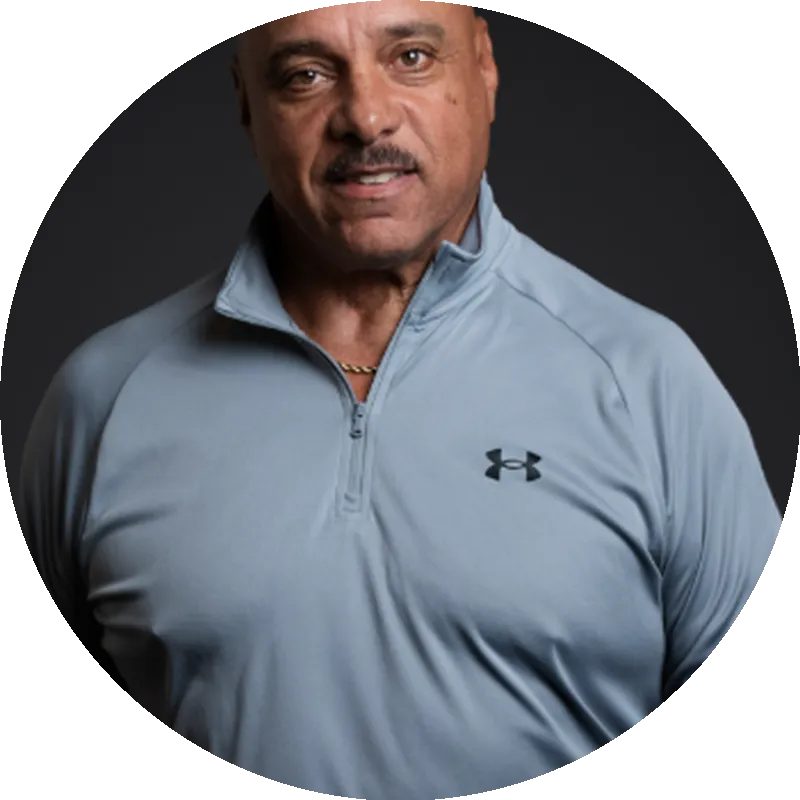 Professional man in a gray Under Armour pullover, smiling, representing expertise in concrete and excavation industry partnership with Bulldog Concrete