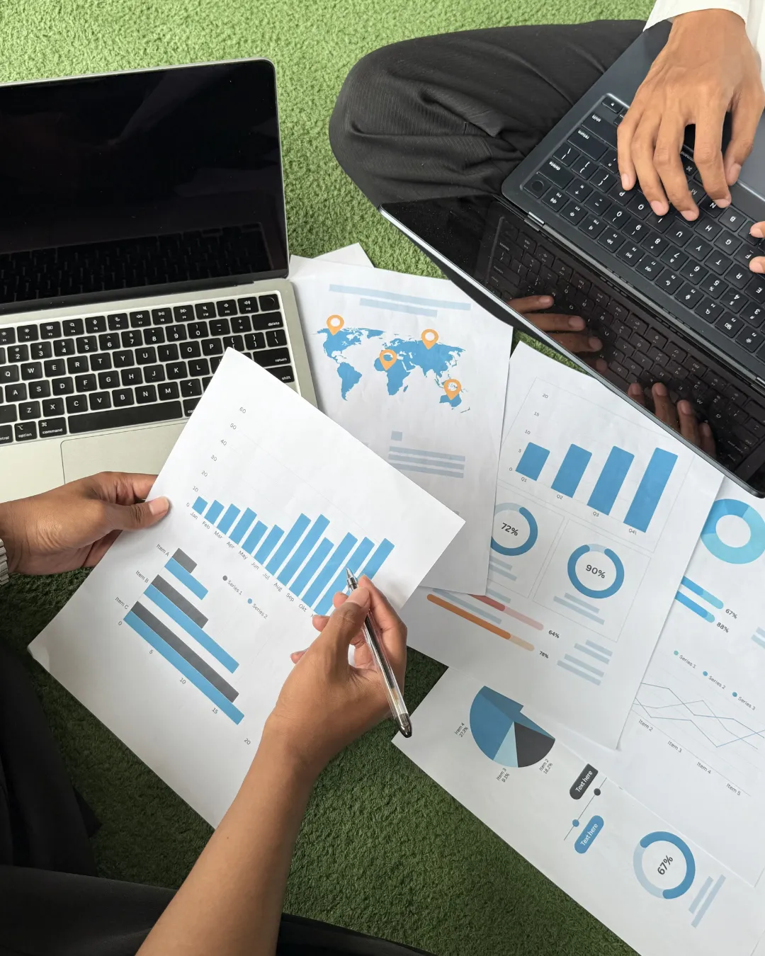 Hands reviewing charts and business performance data during a deep-dive strategy session — representing Kristen Arnold’s process for auditing team structure and systems.
