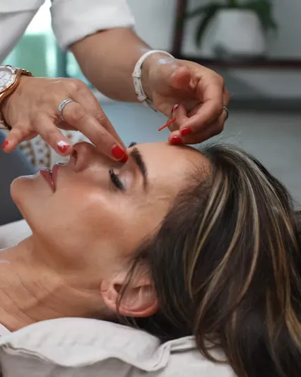Woman receiving professional skin analysis at Lumina Skin and Aesthetics