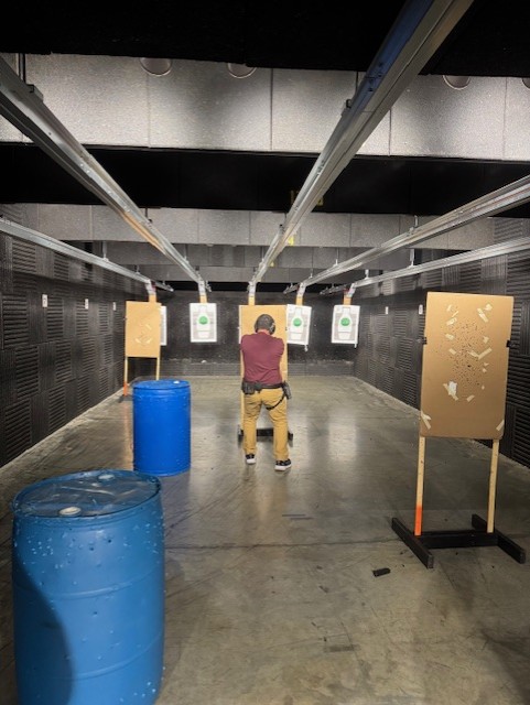 A man in camouflage walking across a street