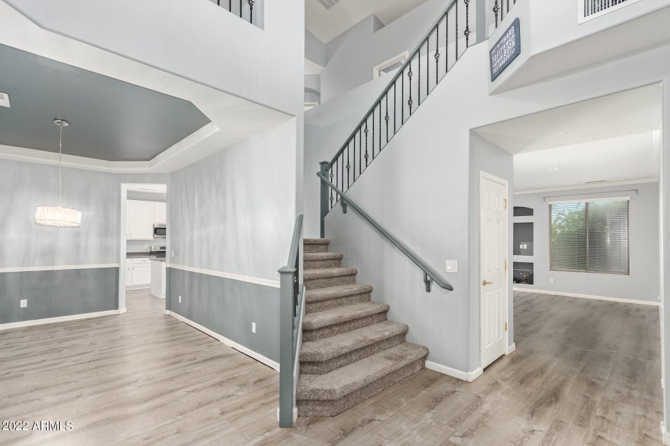 Carpet staircase with 2 tone grey walls 