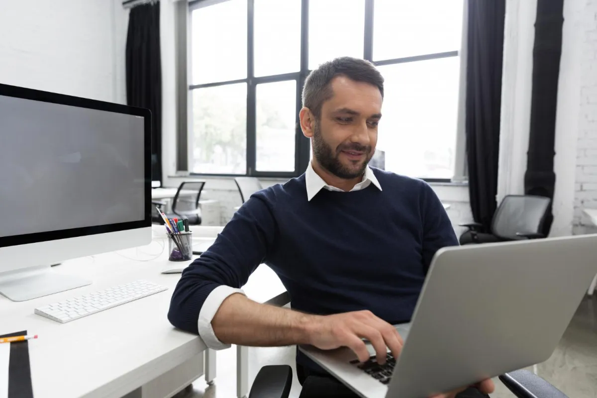 Man working on a laptop while learning how to protect your retirement plan from lifestyle risk and income loss.