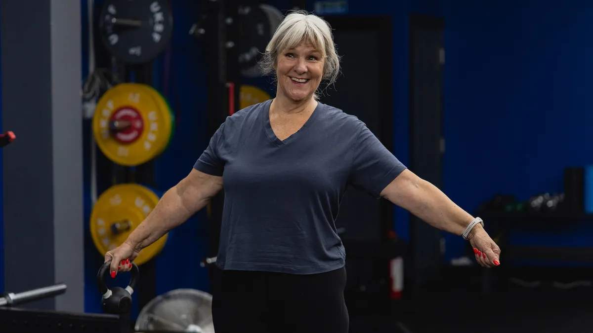 Smiling 1 Force member holding a kettlebell.