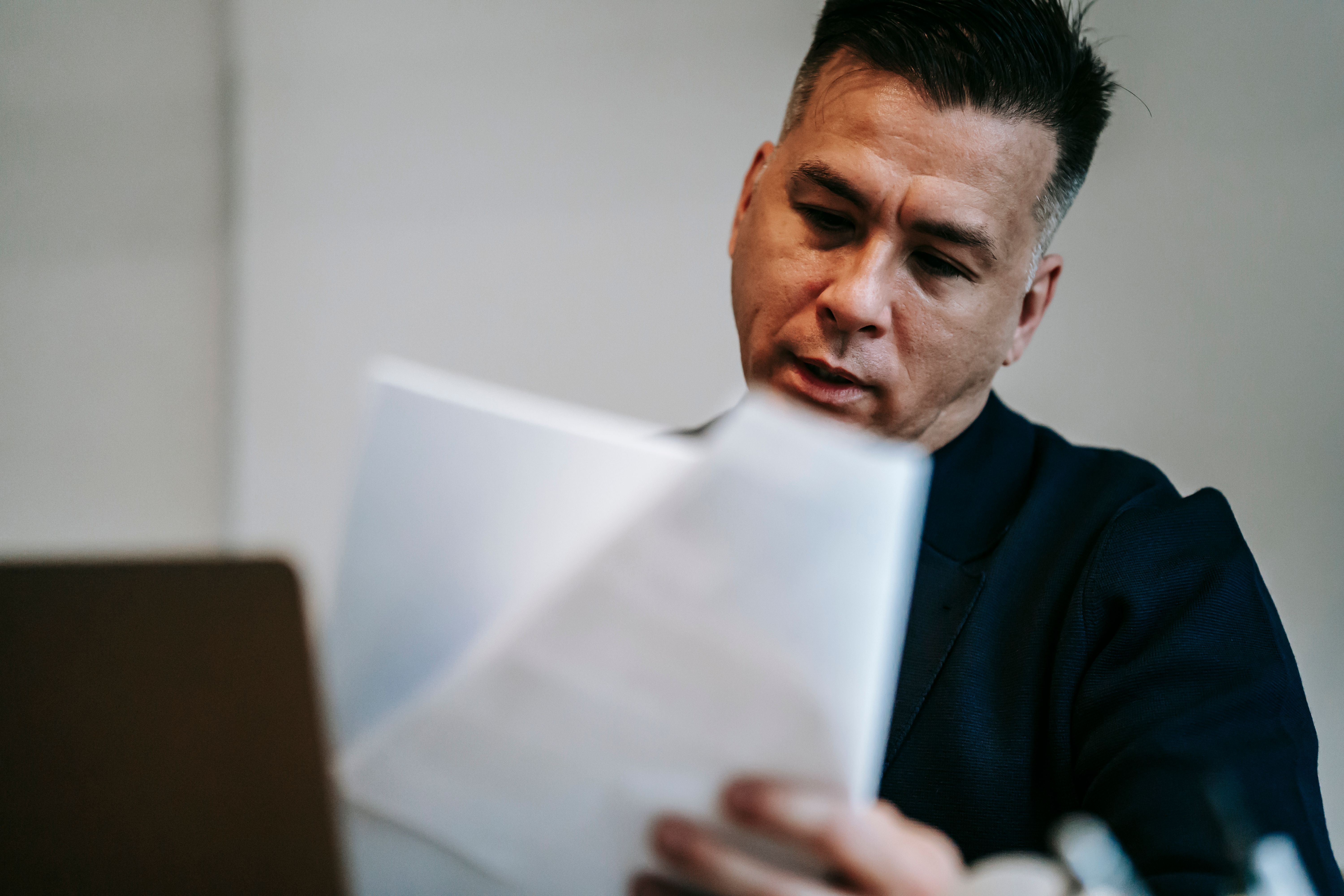 Small business owner reviewing cash flow and loan documents before applying for funding