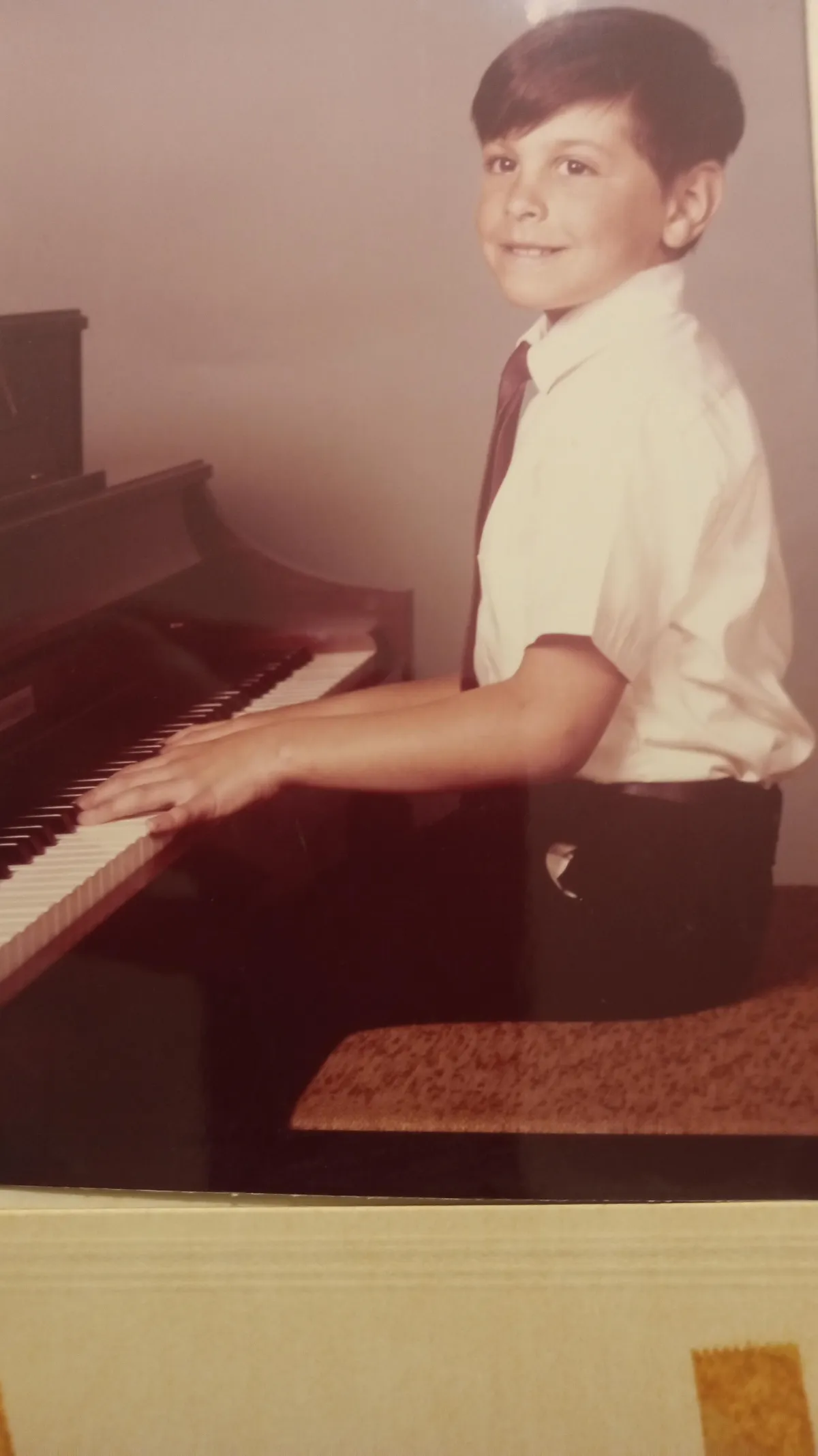 Image of Greg Pane playing the piano when he was first staring to play the piano