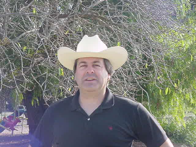 Greg Pane outside wearing a white cowboy hat