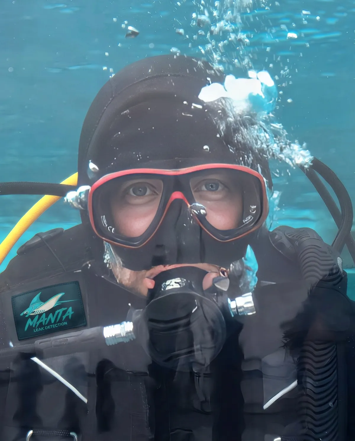 Manta Leak Detection technician preparing scuba gear before a pool leak inspection