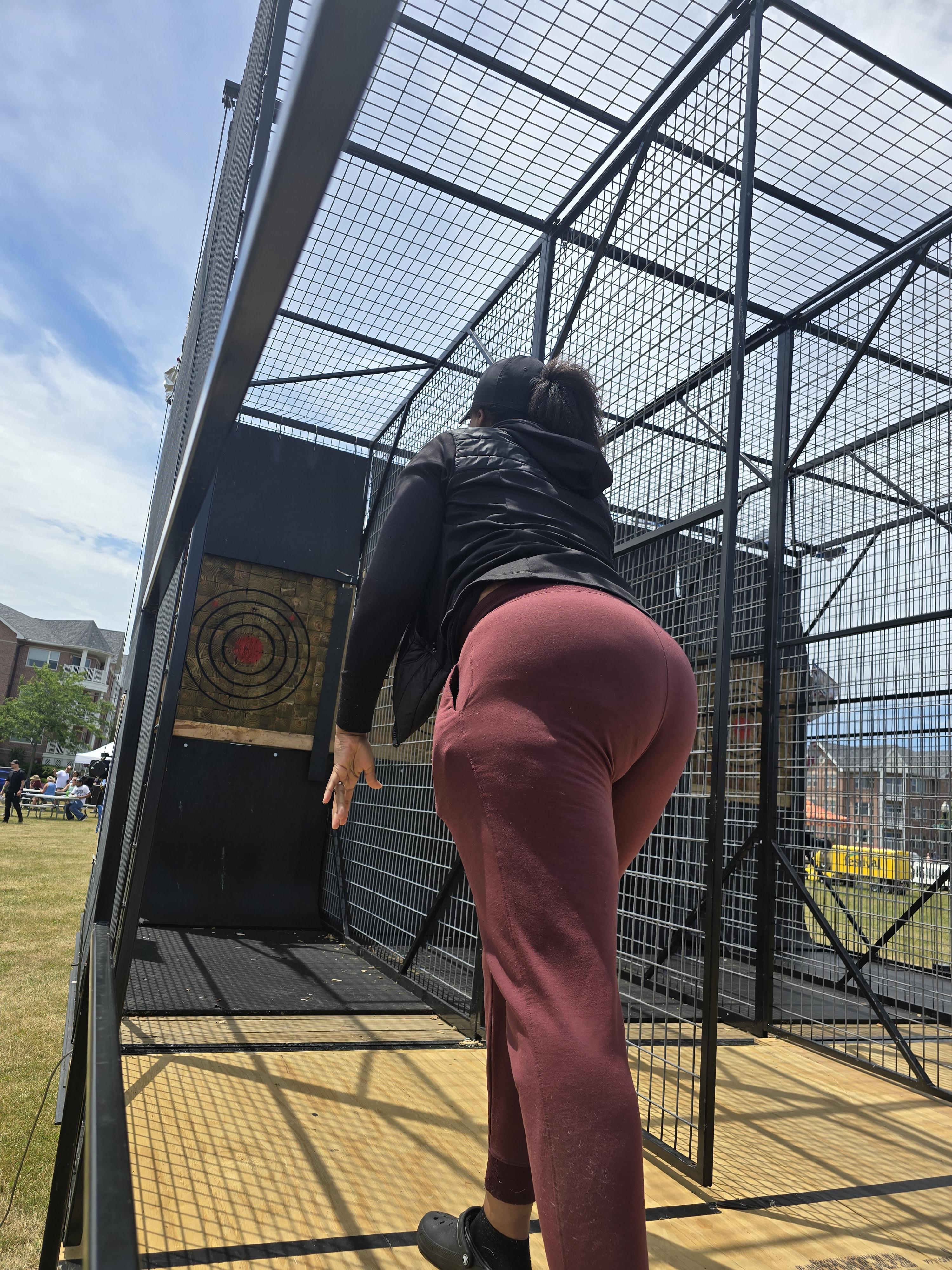 Guests throwing axes at Hold My Beer’s mobile axe throwing unit during a Kenosha community event