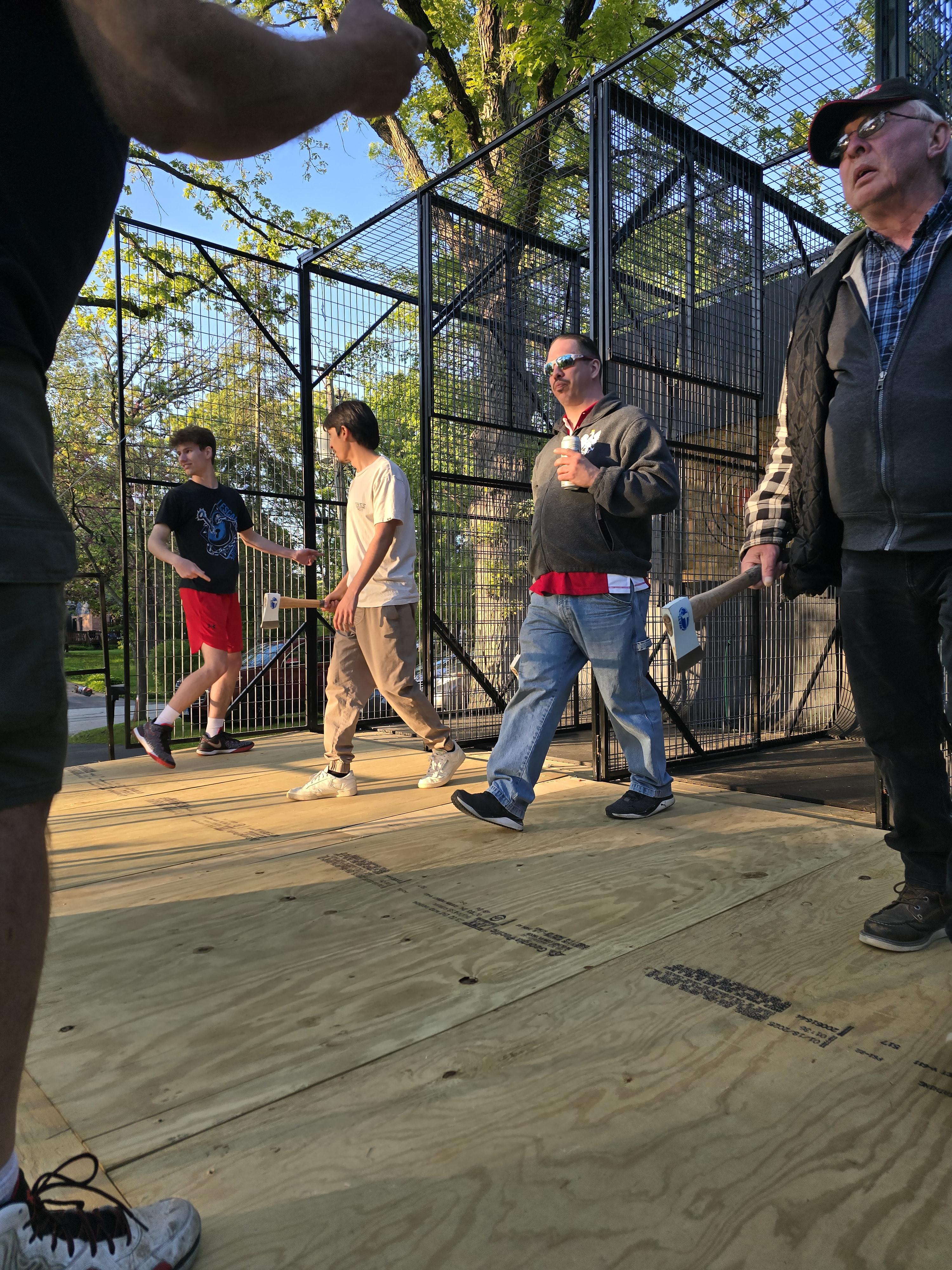 Guests throwing axes at Hold My Beer’s mobile axe throwing unit during a GRADUATION PARTY IN KENOSHA