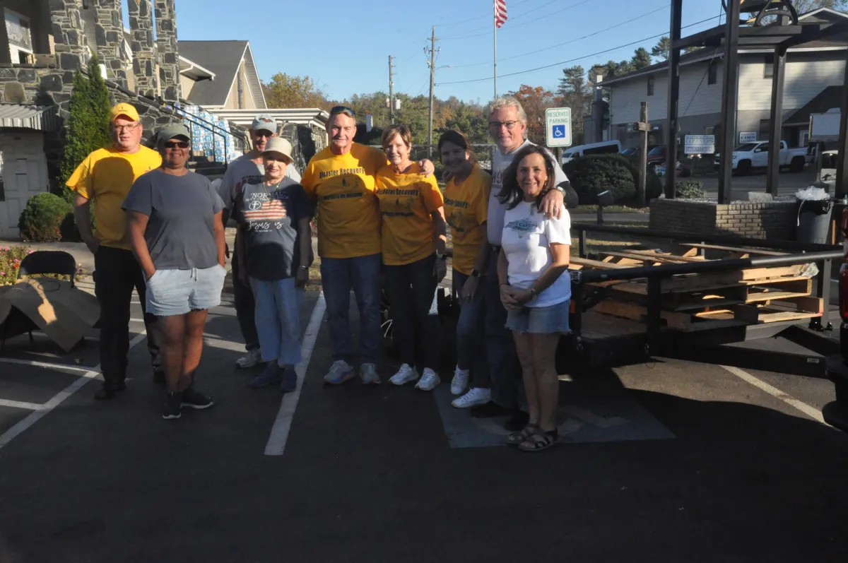 man standing in front of people sitting beside table with laptop computers