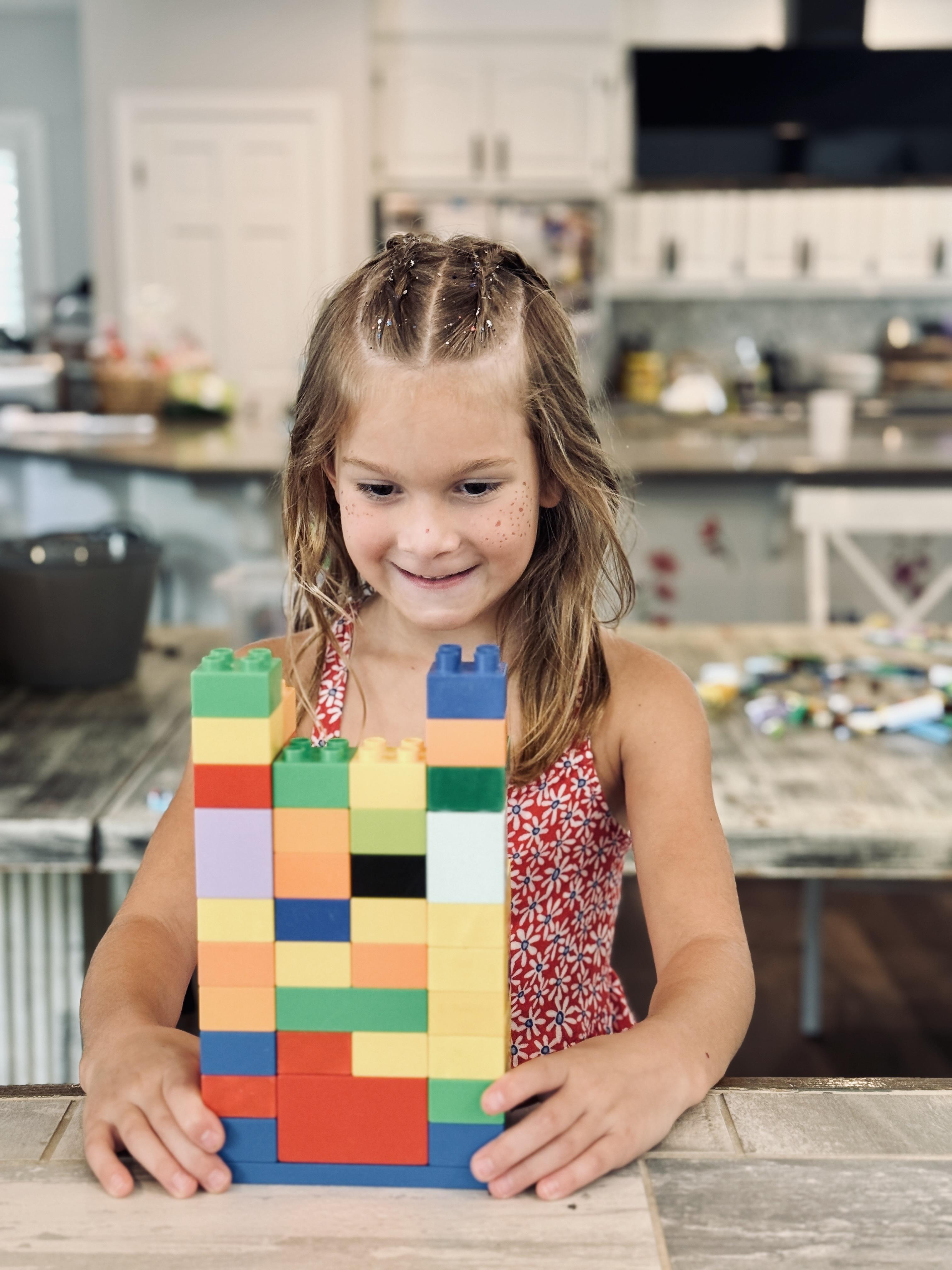Robrik robot mascot building technical brick structures with stop-motion film equipment