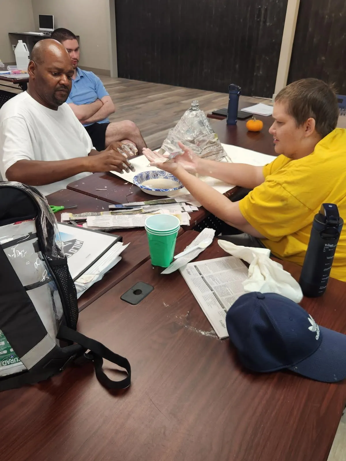 Caregiver and resident sharing a quiet evening activity in a comfortable living room