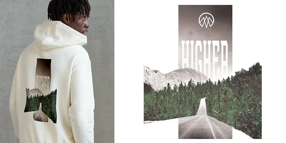 Collaborative hoodie design titled "Higher Road" by The Higher Calling and High Peaks. The artwork features a stylized road leading into a forest with mountainous scenery and the word "HIGHER" in bold, fading typography. The design emphasizes a journey and connection to nature, reflecting Axe & Pail's expertise in creating visually engaging and thematic apparel.