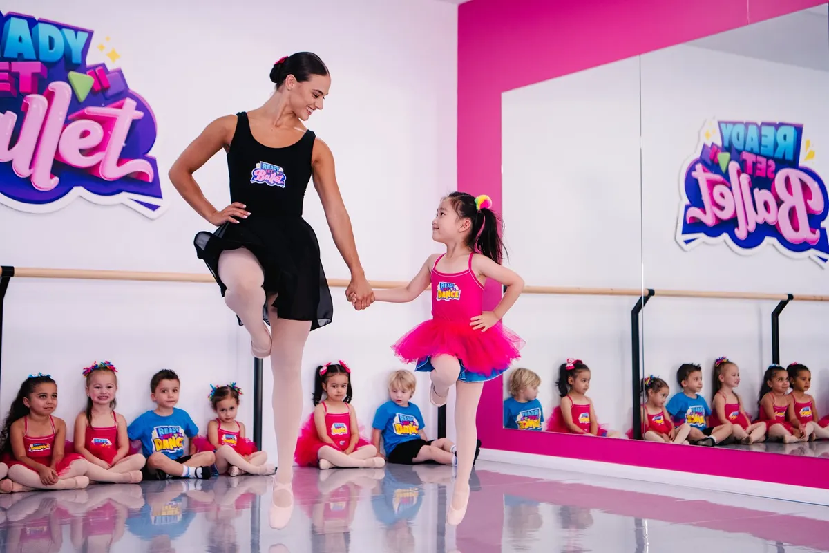 Ready Set Ballet teacher dancing with a preschooler at the barre at The Tribe Collective, Cardiff