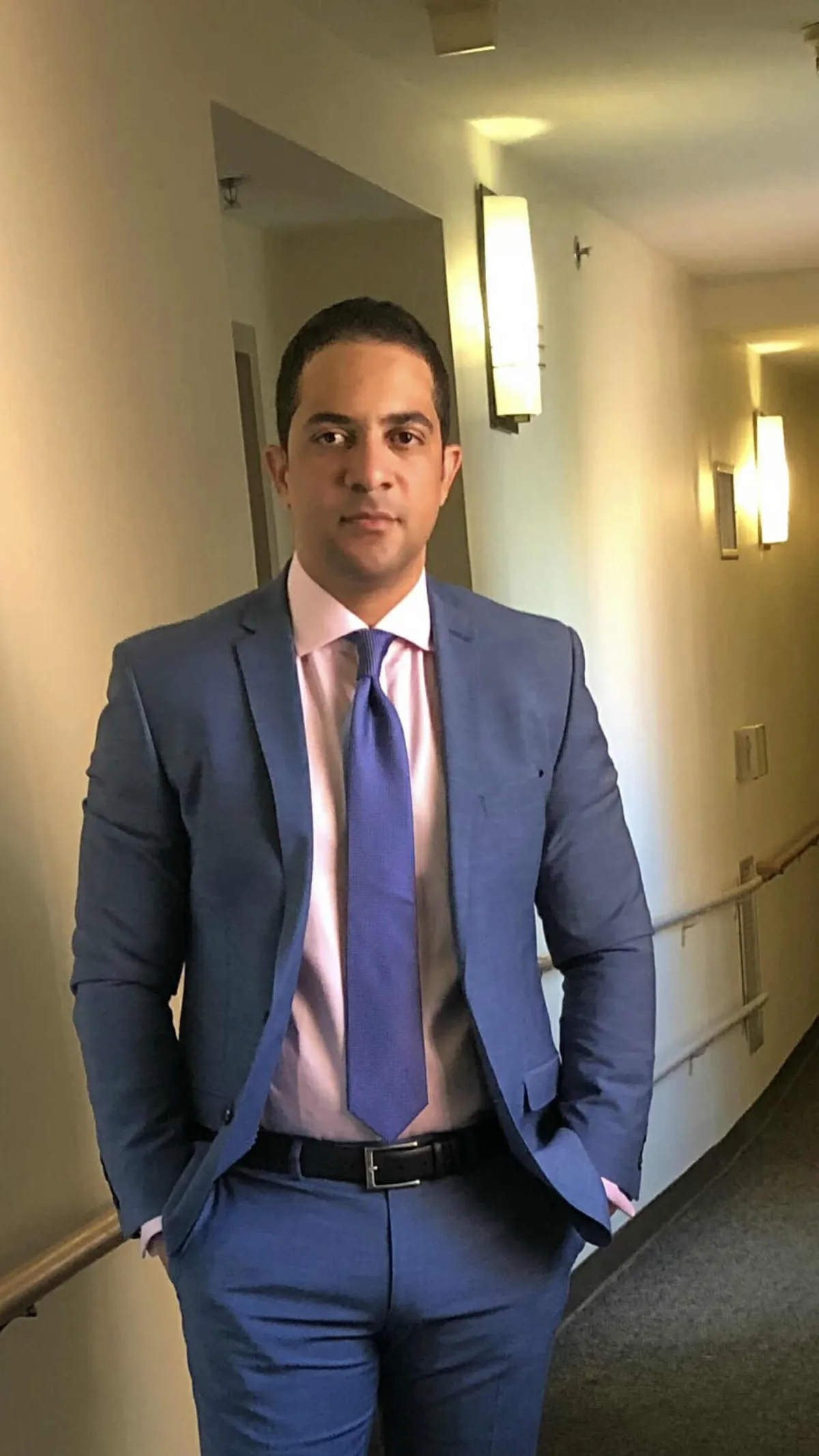 man wearing watch with black suit