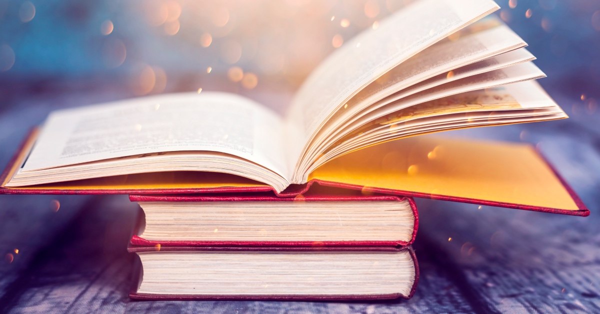 Open book with light representing ancient wisdom and metaphysical healing