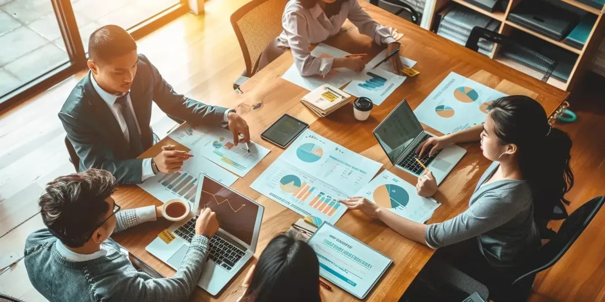 Image of Employees Collaborating Around the Table On Company Finances