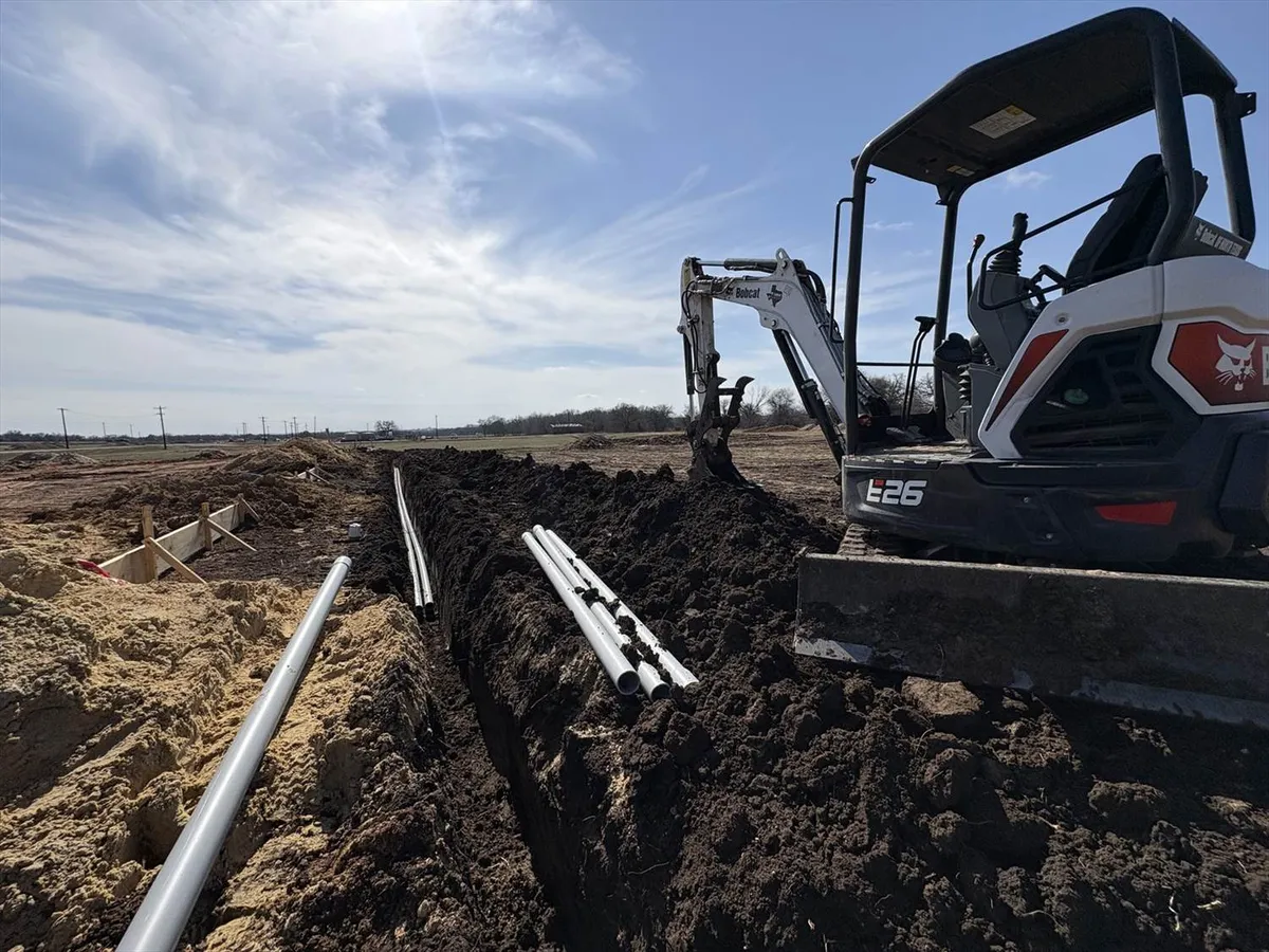 Construction workers pulling cable on commercial job site