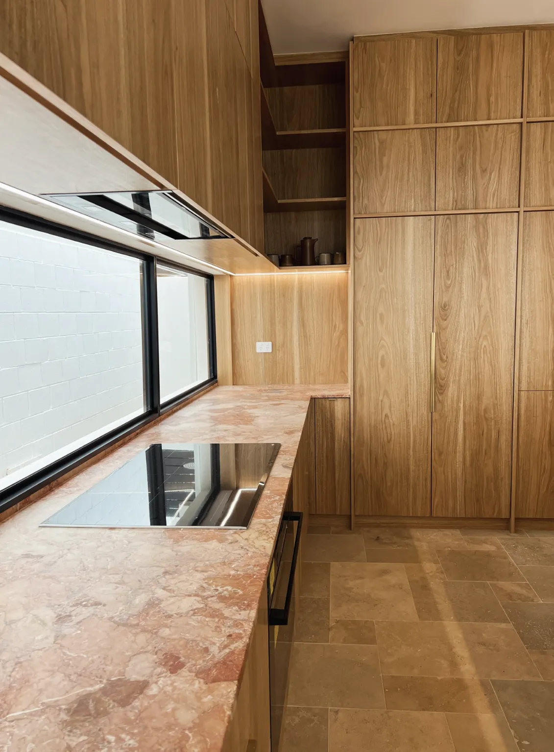A kitchen with a center island and a refrigerator