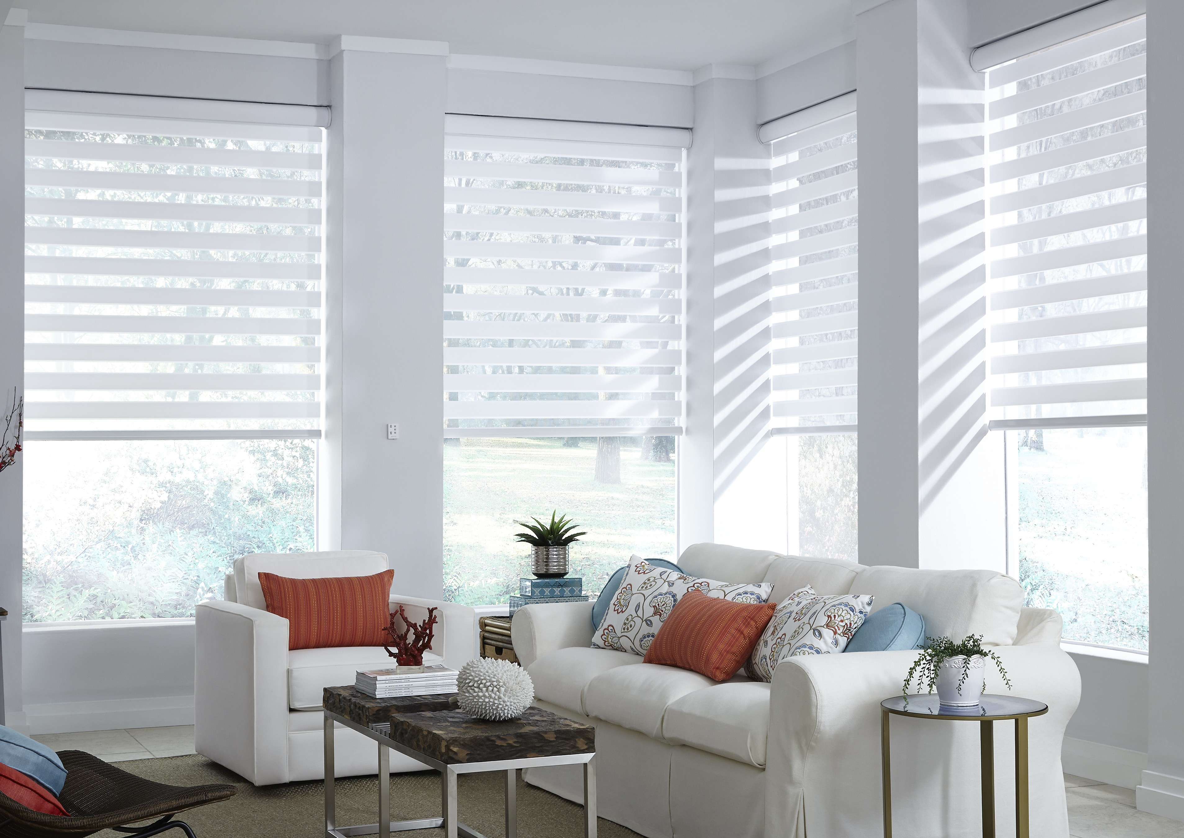 Custom zebra roller shades filtering light in a bright living room