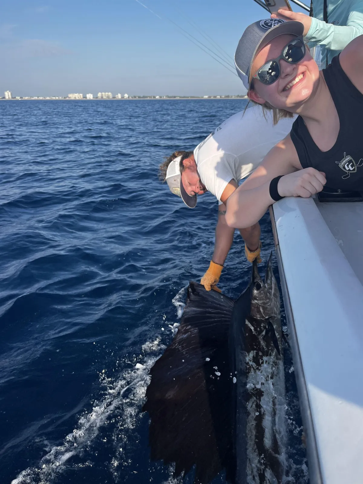 Crew releasing a big Sailfish back into the South Florida waters from the boat