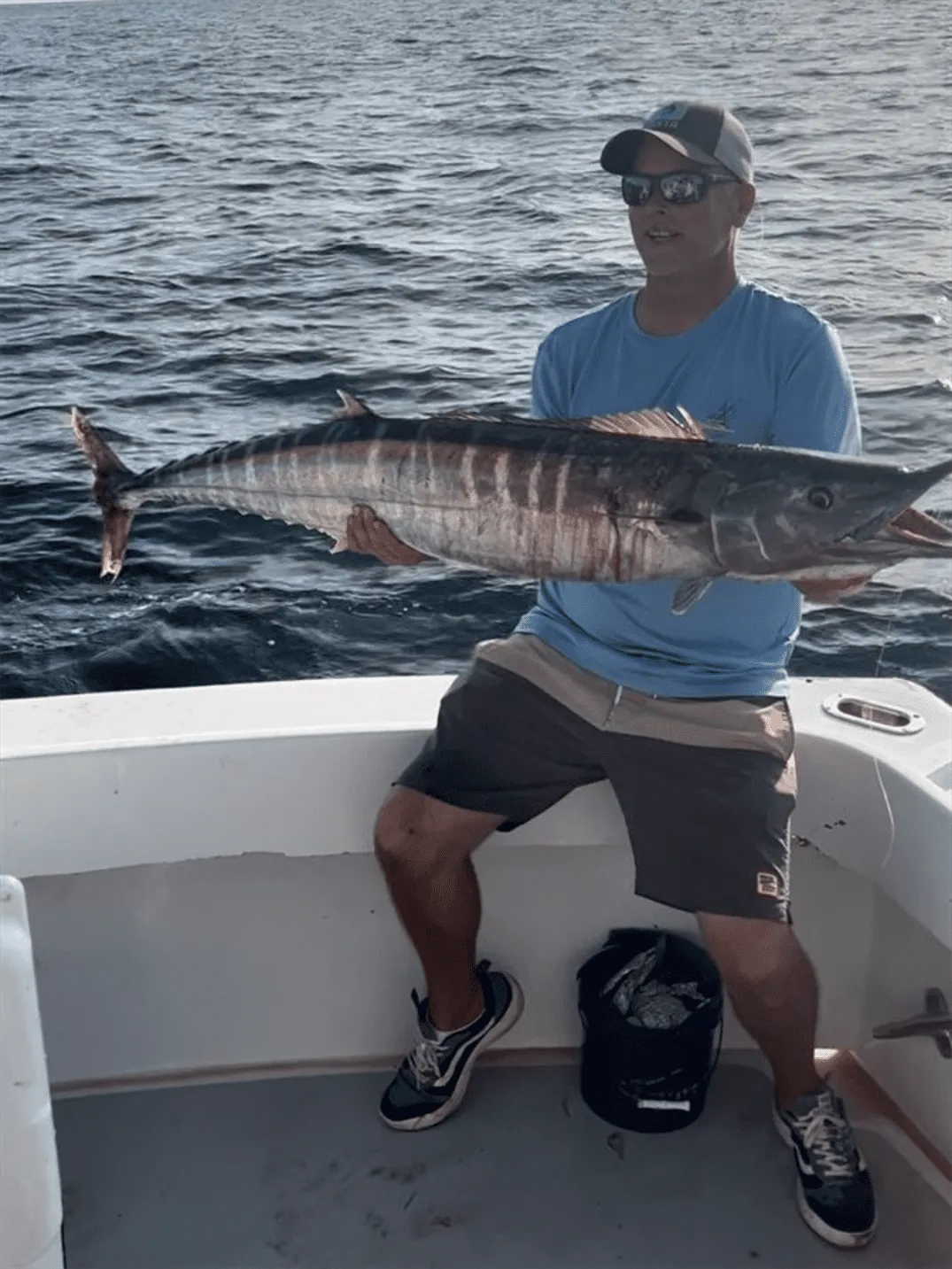 Angler fighting a fish from the fighting chair during a full day sport fishing trip