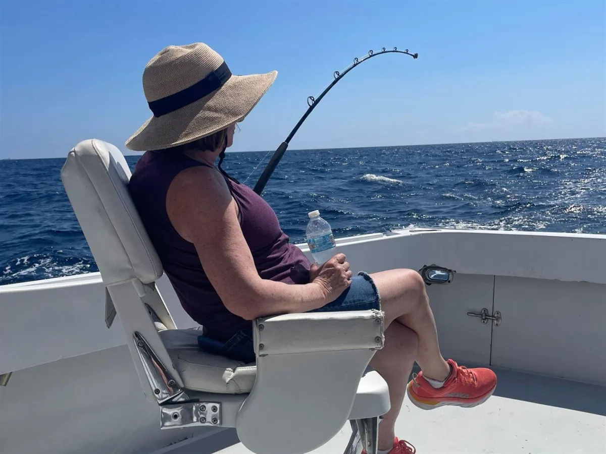 Angler fighting a fish from the fighting chair during a full day sport fishing trip