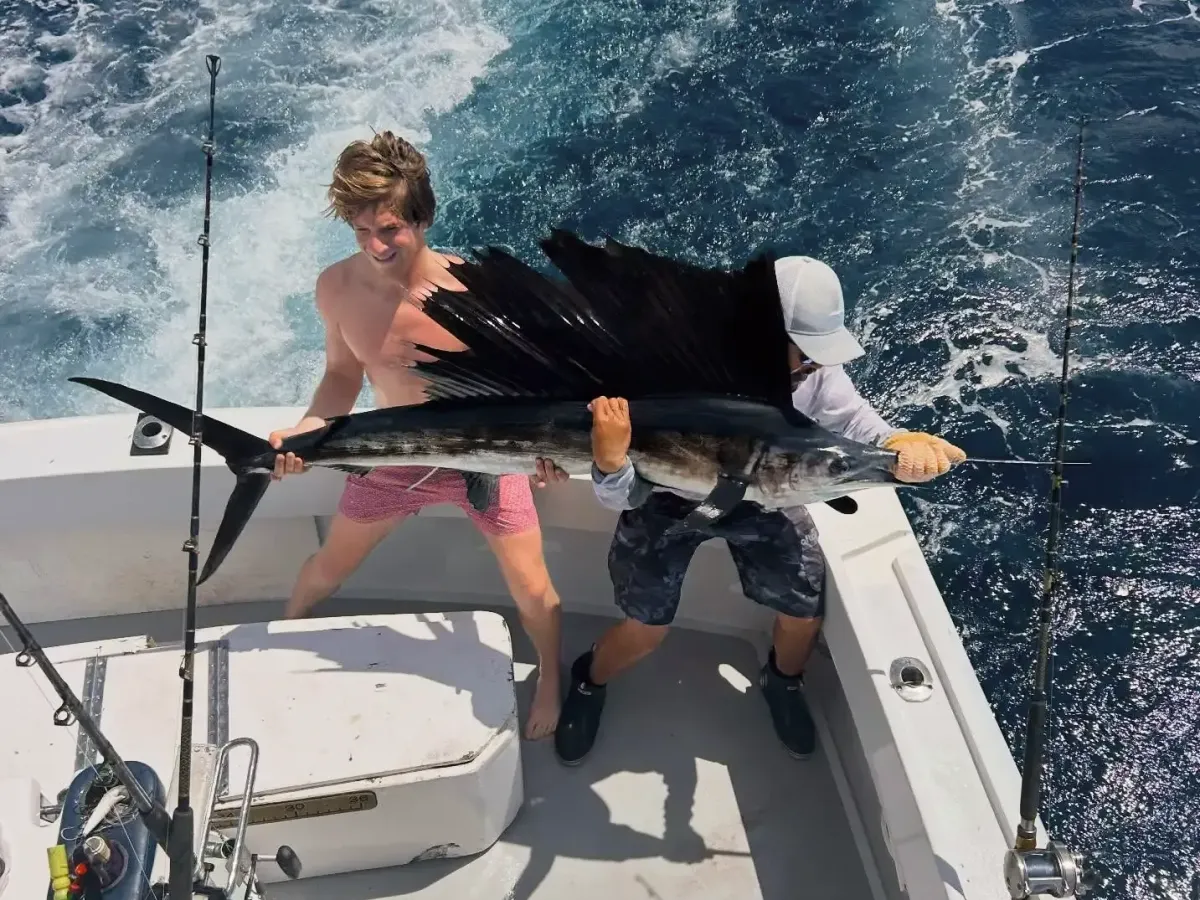 Angler fighting a fish from the fighting chair during a full day sport fishing trip