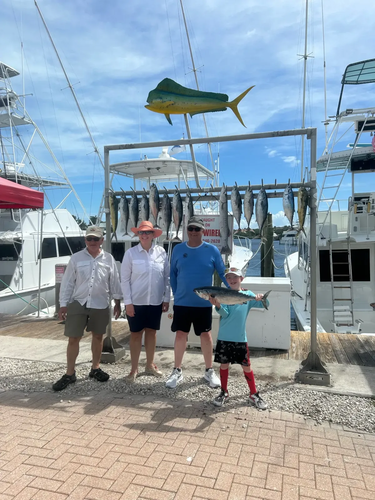Family showing their successful daily catch on the fish hanging rack aboard Killin Time Charter