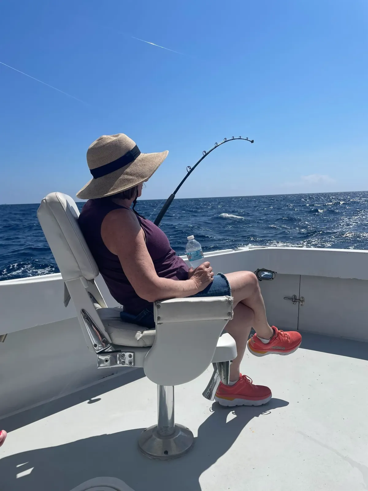 Killin Time charter boat cruising near the Hillsboro Inlet Lighthouse with fishing rods ready