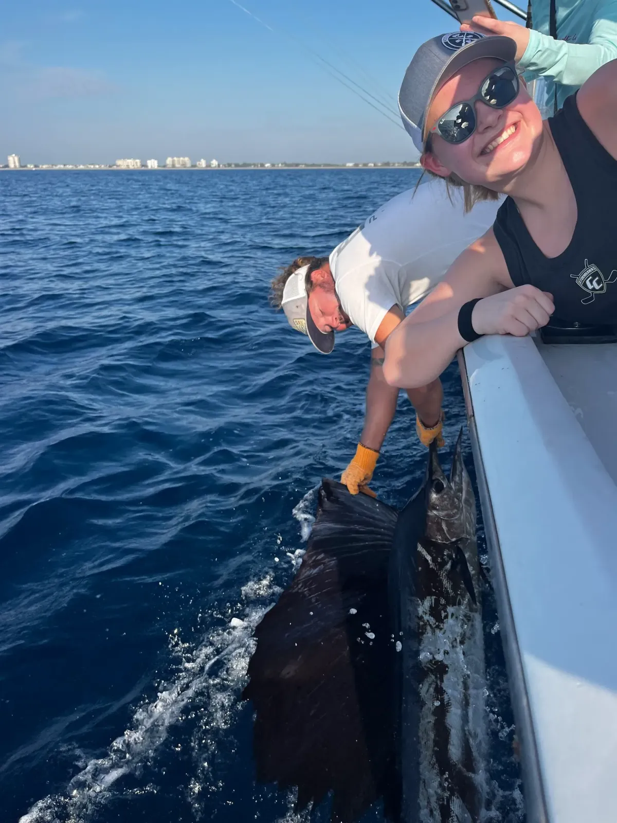 Crew releasing a big Sailfish back into the South Florida waters from the boat