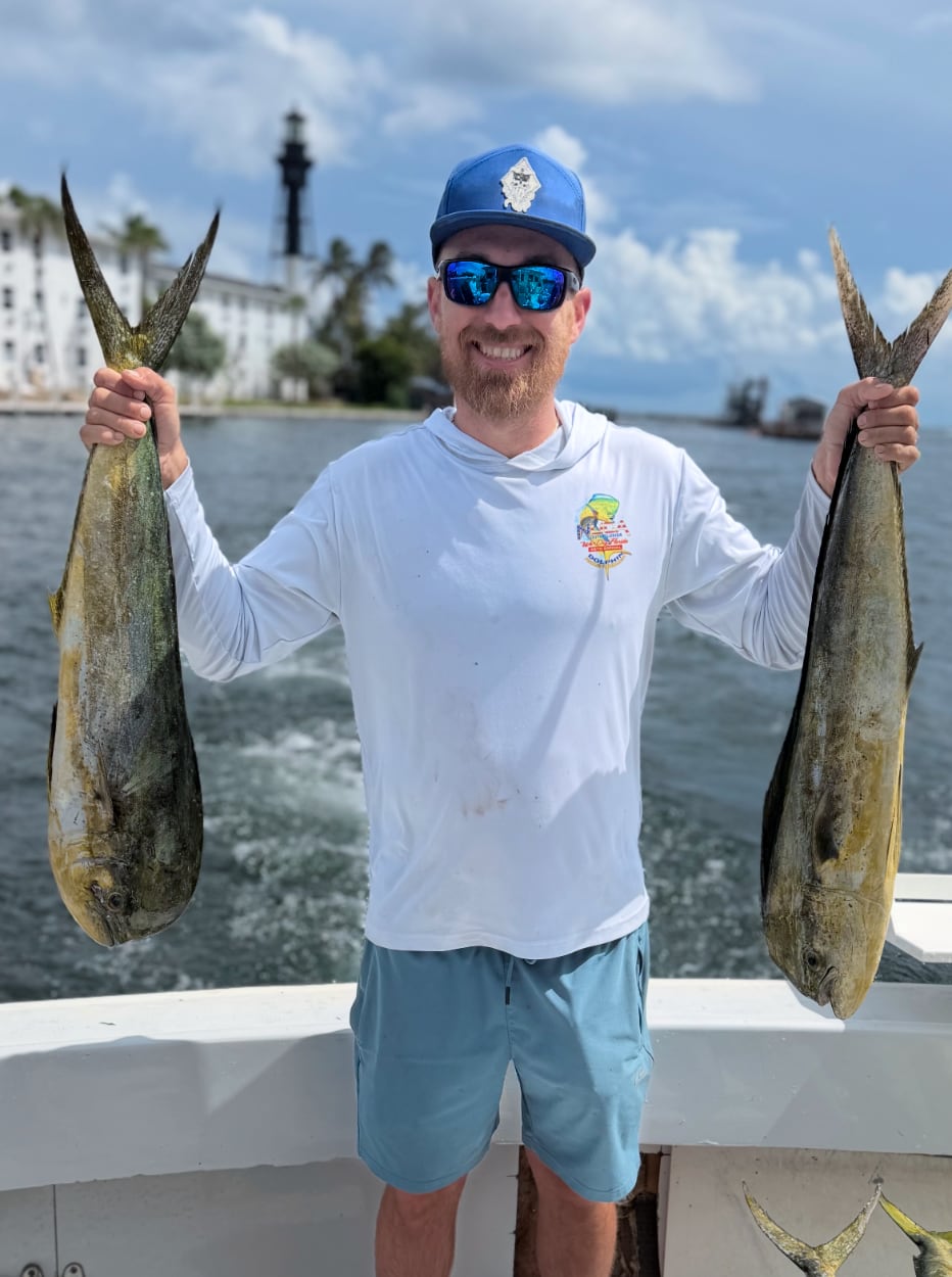 Anglers displaying a huge catch of Mahi Mahi and Barracuda on the dock after a Pompano Beach charter