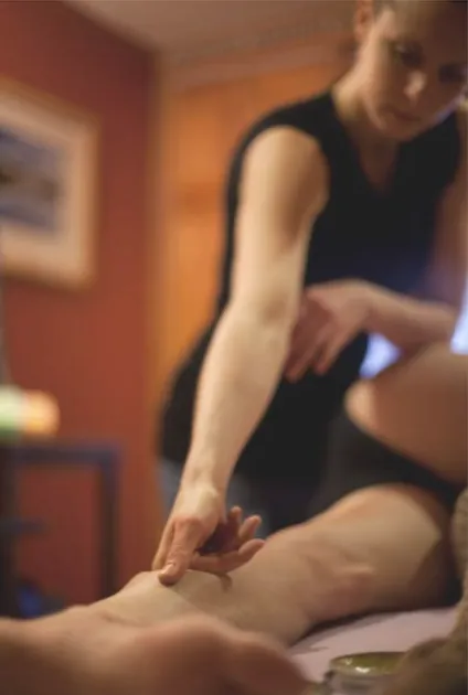 three bodies, faye morrison, a woman, doing hand on healing work on a body, 