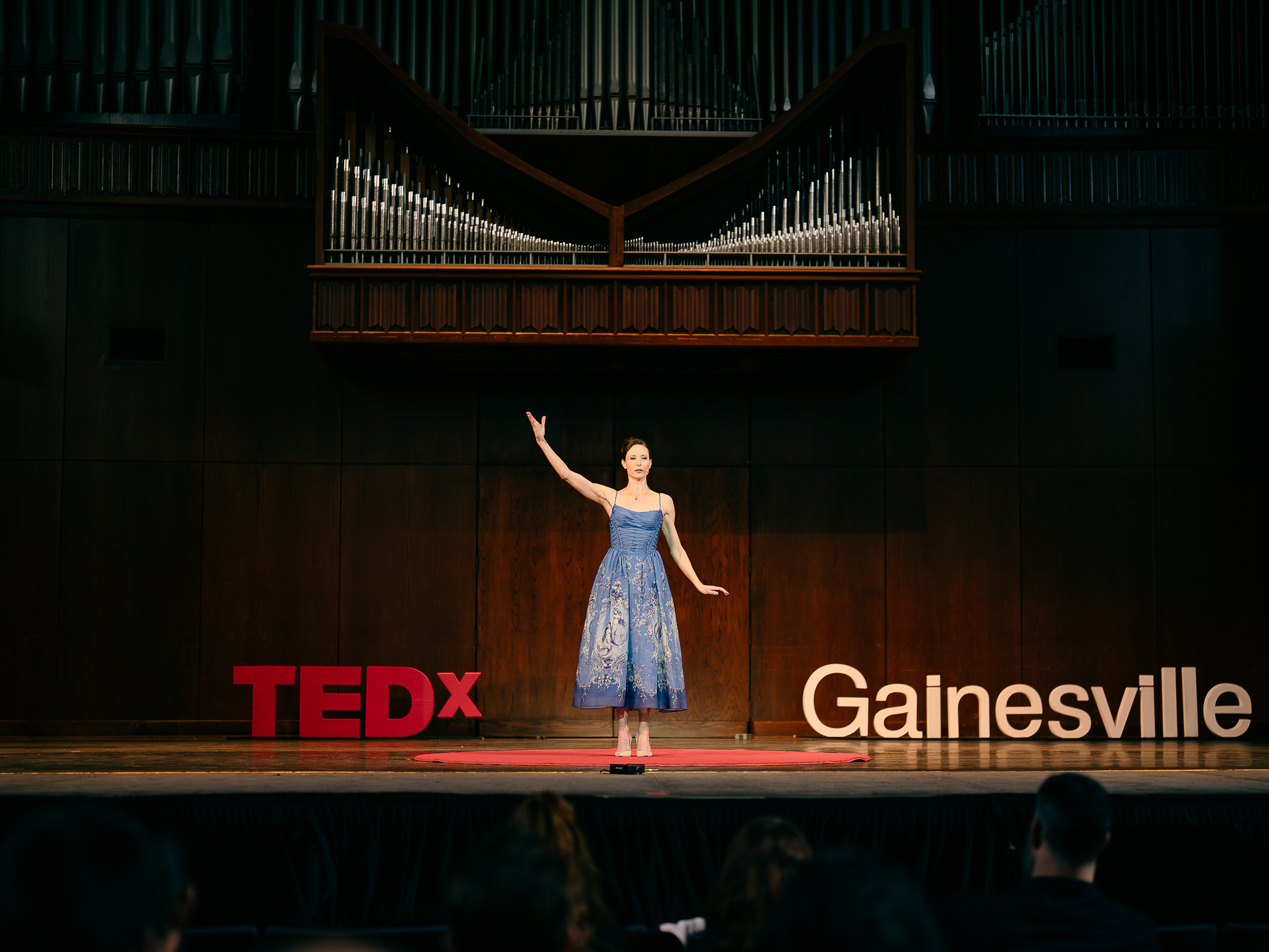three bodies, faye morrison, a woman standing on stage speaking 