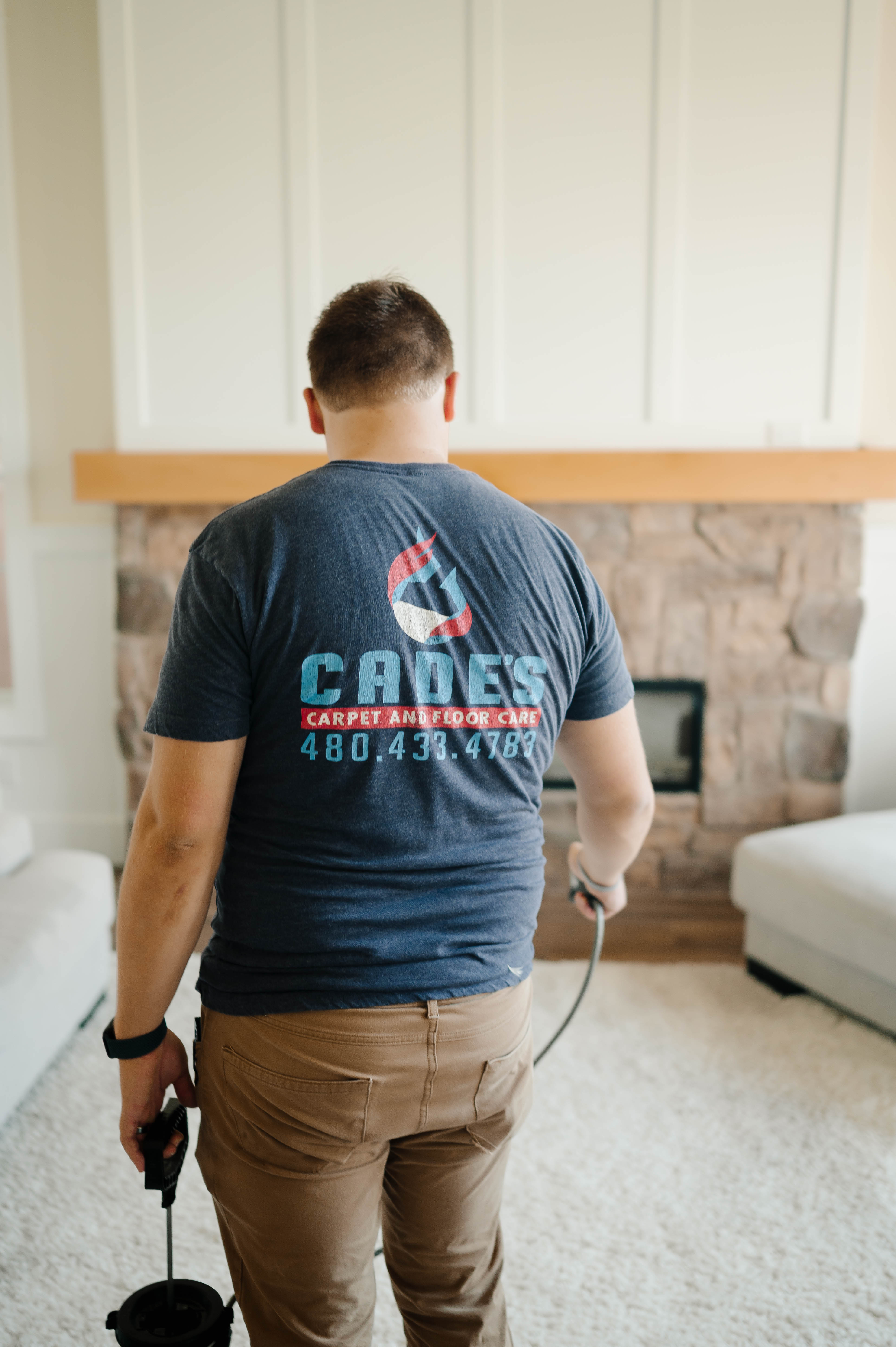 Cade, founder of Cade's Carpet and Floor Care, smiling in a clean sunlit living room