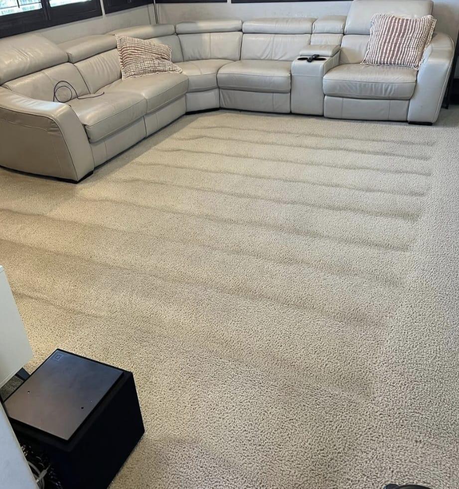 Deep cleaning steam extraction tool in action revealing clean carpet