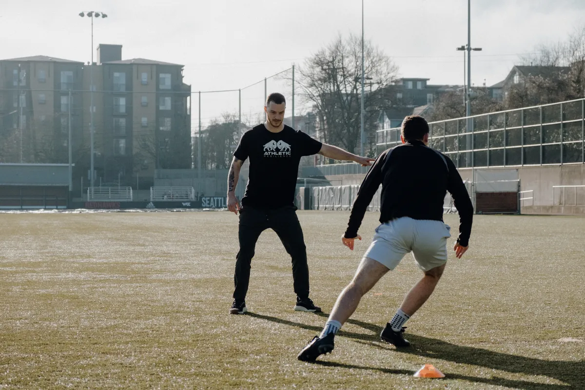 Athletic Resilience coach working with an athlete on the field