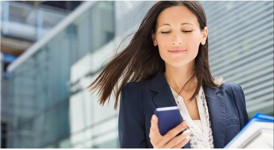 Confident woman taking control of her divorce process by booking a legal consultation on her mobile phone.