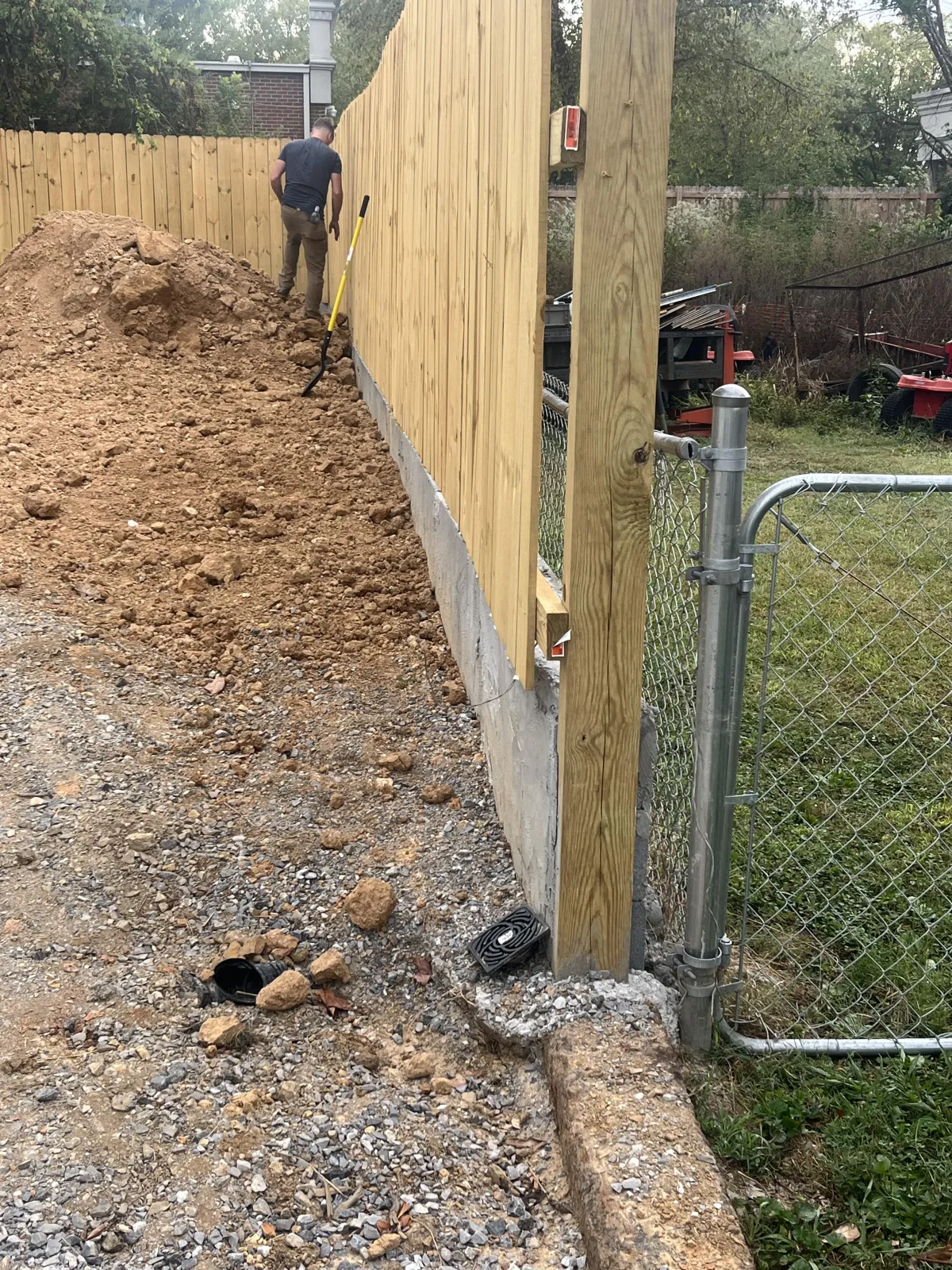 wooden privacy fence installation along property line